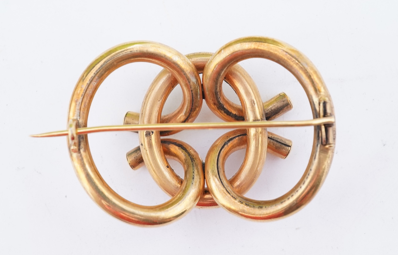A group of gilt metal/pinchbeck jewels, 19th and early 20th century, comprising: a brooch of knotted design; two gate bracelets; a fancy link bracelet; an open-faced pocket watch; two oval panel brooches, and two watch c